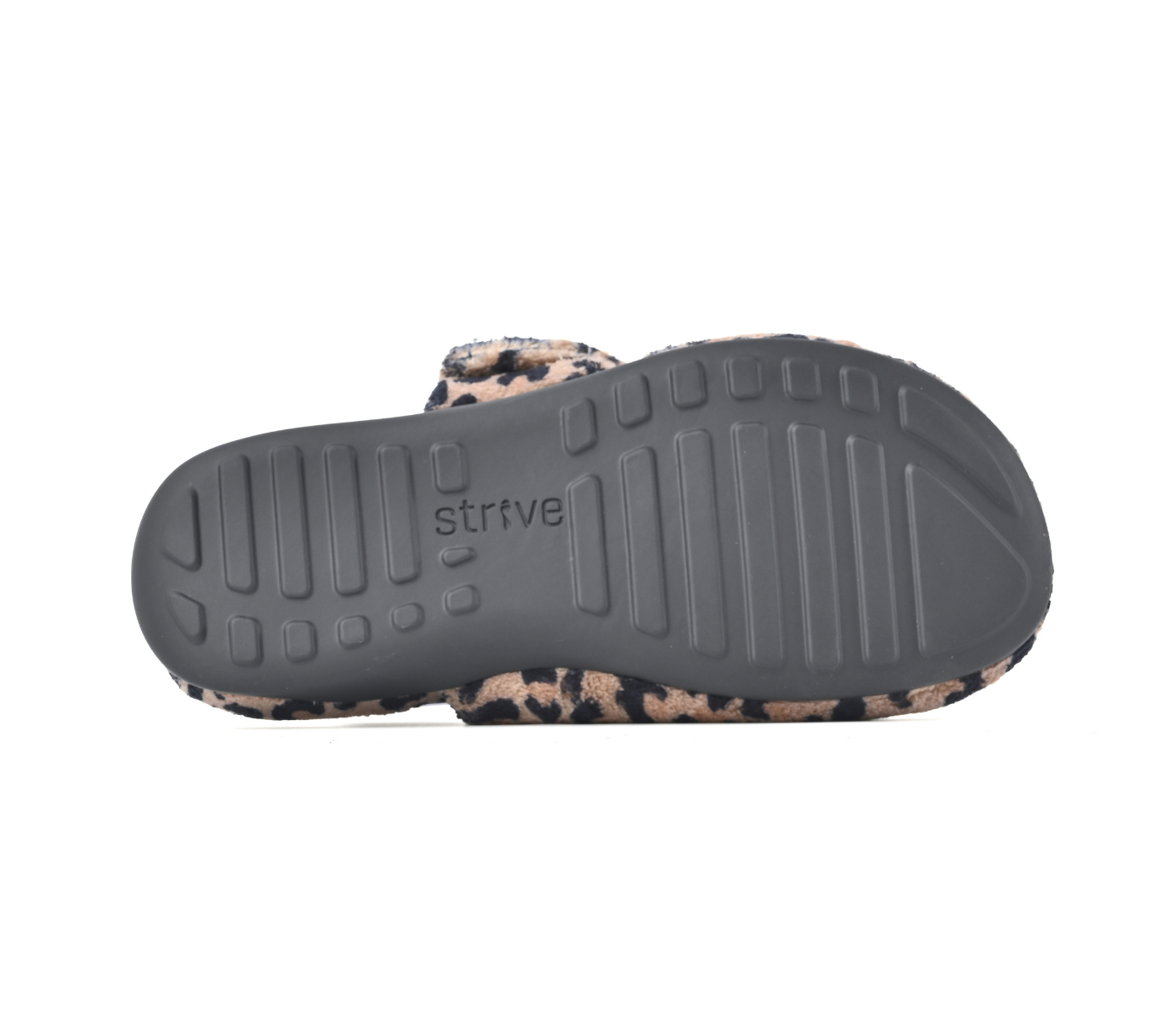 The bottom sole of a Strive brand slide sandal, featuring a dark grey treaded outsole with the 'strive' logo embossed, and a leopard-print upper strap in beige, brown, and black. Strive Footwear Zara Women’s Leopard Print Slippers