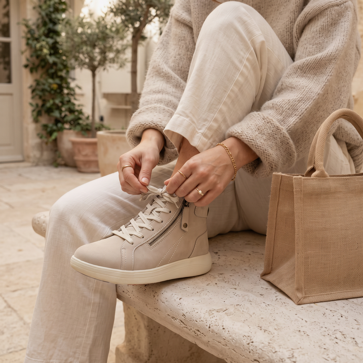 Woman wearing Beige Strive Kensignton supportive hi top trainers in a park