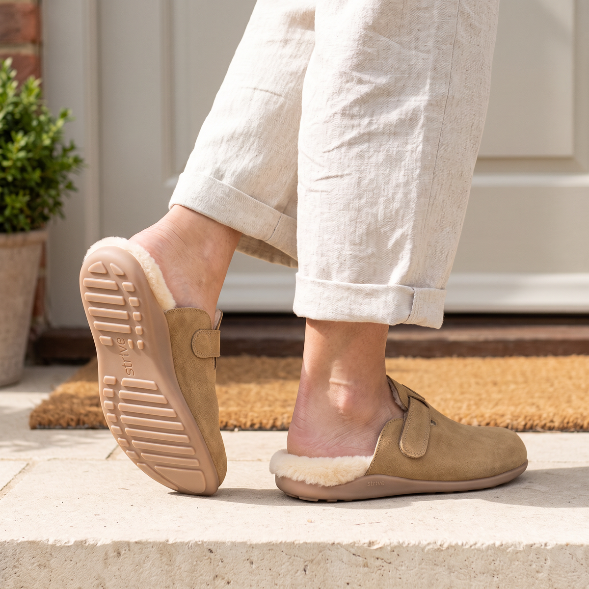 Tan Strive Kensington trainers styled with a jumper dress