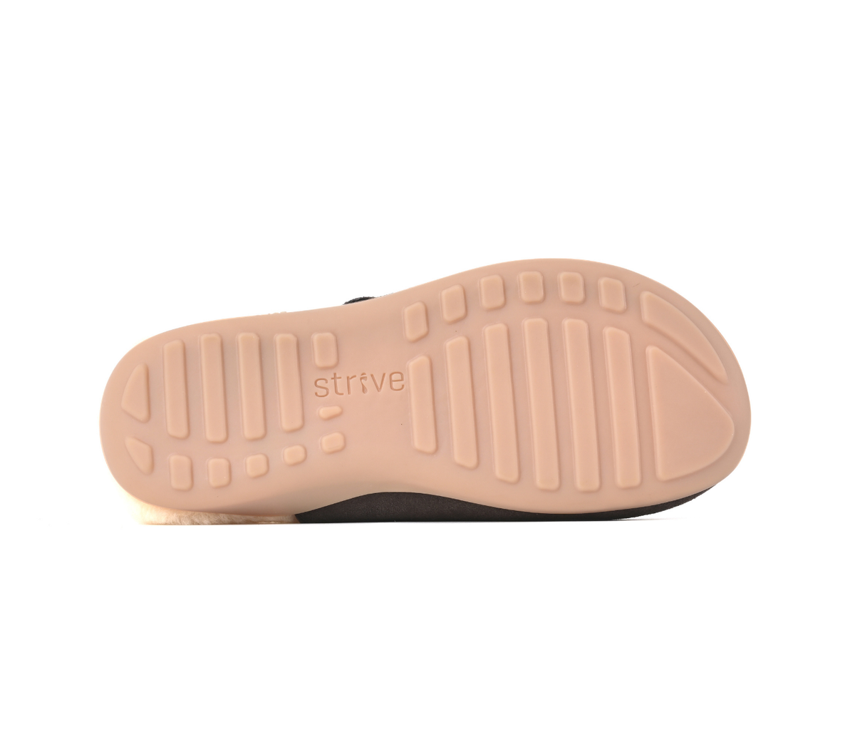 The outsole of a slip-on shoe or sandal, showing a light peach-beige tread pattern with the brand name 'strive' embossed in the center, photographed against a solid white background. Strive Footwear Oslo II Women’s Brown Slippers