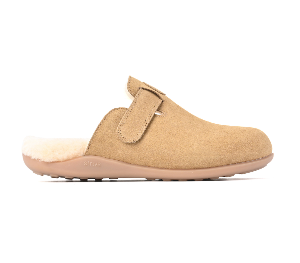 A tan suede clog-style slipper with a plush cream shearling lining and a matching tan sole, shown in profile against a white background. Strive Footwear Oslo II Women’s Tan Slippers