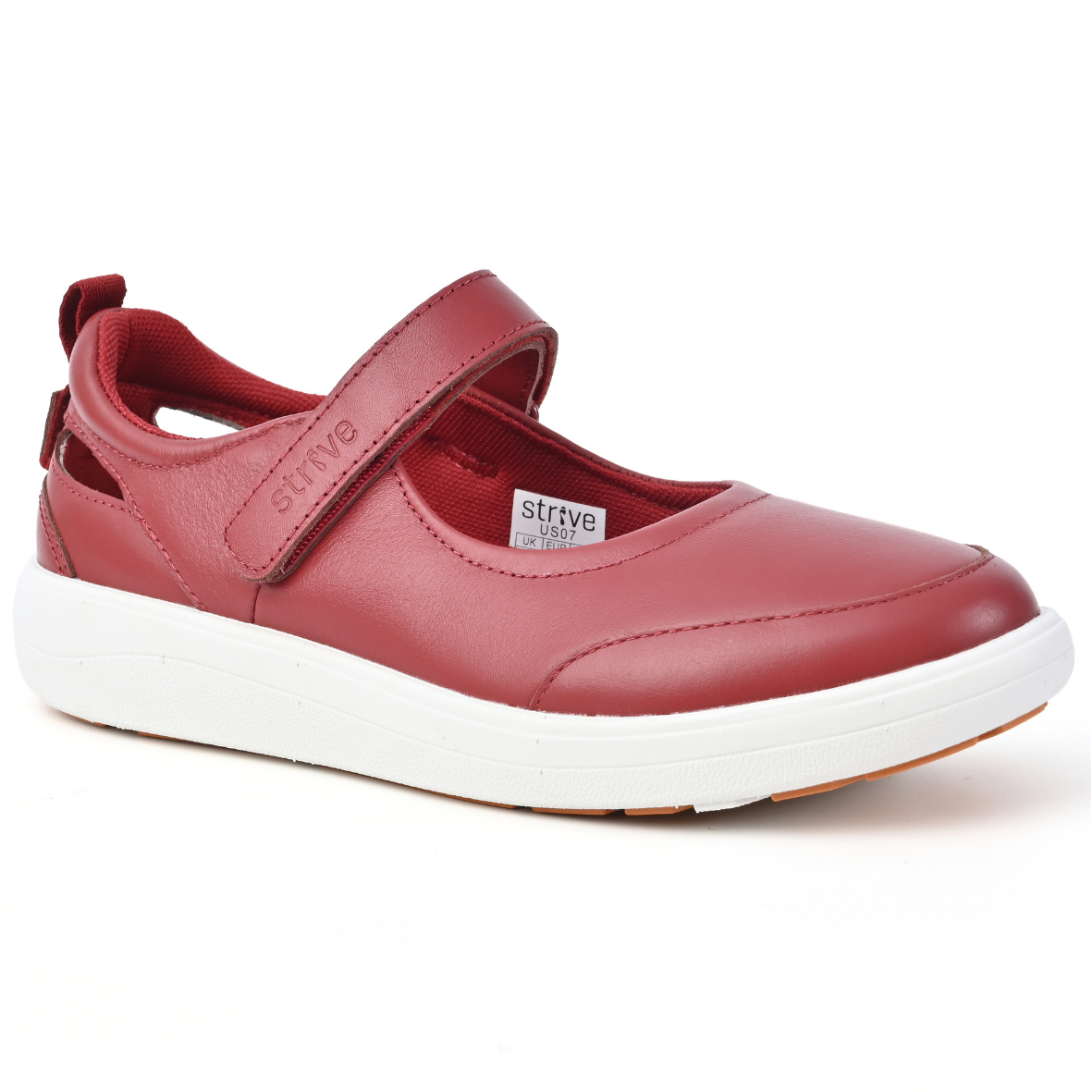 Strive Footwear Skip red leather Mary Jane-style slip-on shoe with a hook-and-loop strap and a thick white platform sole, shown from a three-quarters angle on a white background.