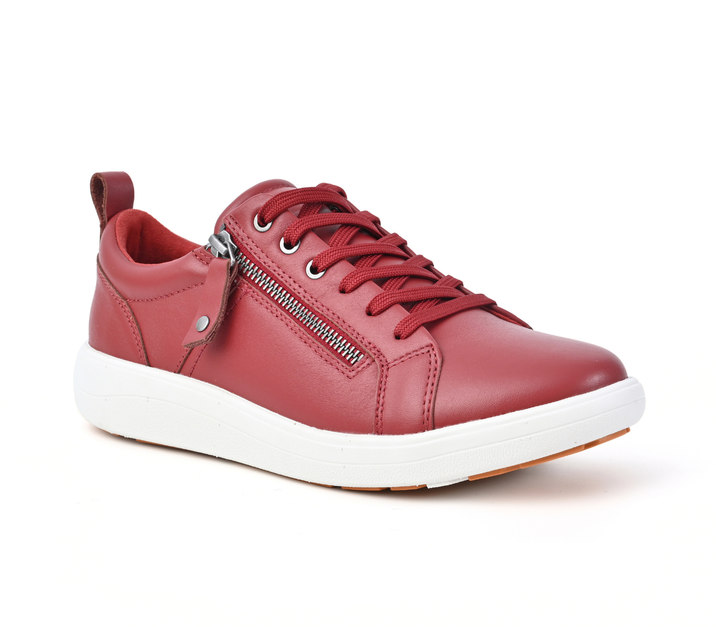 A red leather low-top sneaker with a side zipper, matching red laces, and a thick white sole, shown from a three-quarters angle on a white background.