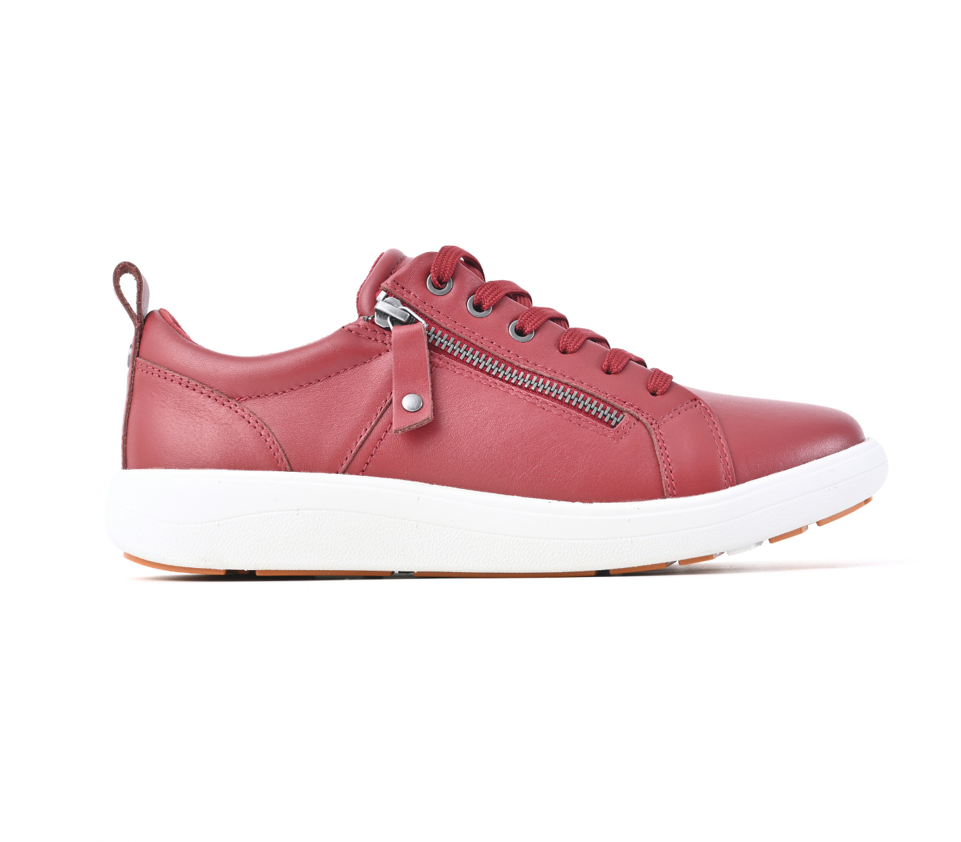 A red leather low-top sneaker with a white sole, featuring a zippered side detail and matching red laces, shown in a side profile on a white background. Strive Footwear Talia Coral Red Trainer Shoes