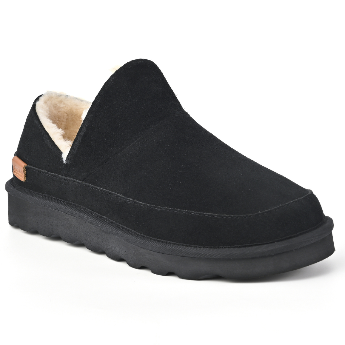 A single black slip-on slipper with a plush beige shearling lining and a thick black sole, shown from a three-quarters angle on a white background. Strive Footwear Women’s Alaska Black Slippers