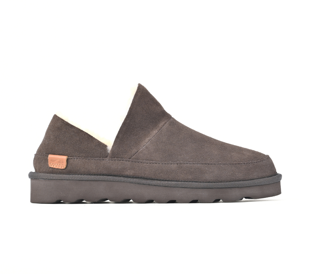 A single dark brown suede slip-on shoe with a thick lug sole and a small tan brand patch on the heel, shown against a plain white background. Strive Footwear Women’s Alaska Brown Slippers