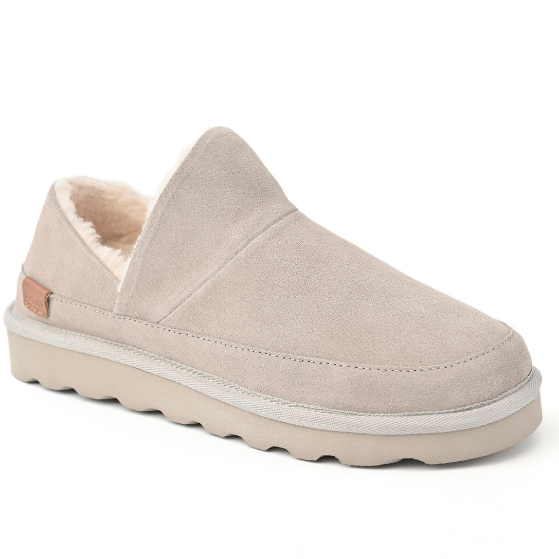 A single slip-on slipper in light taupe suede with a soft cream sherpa lining and a chunky matching sole, shown from a three-quarters angle on a white background.