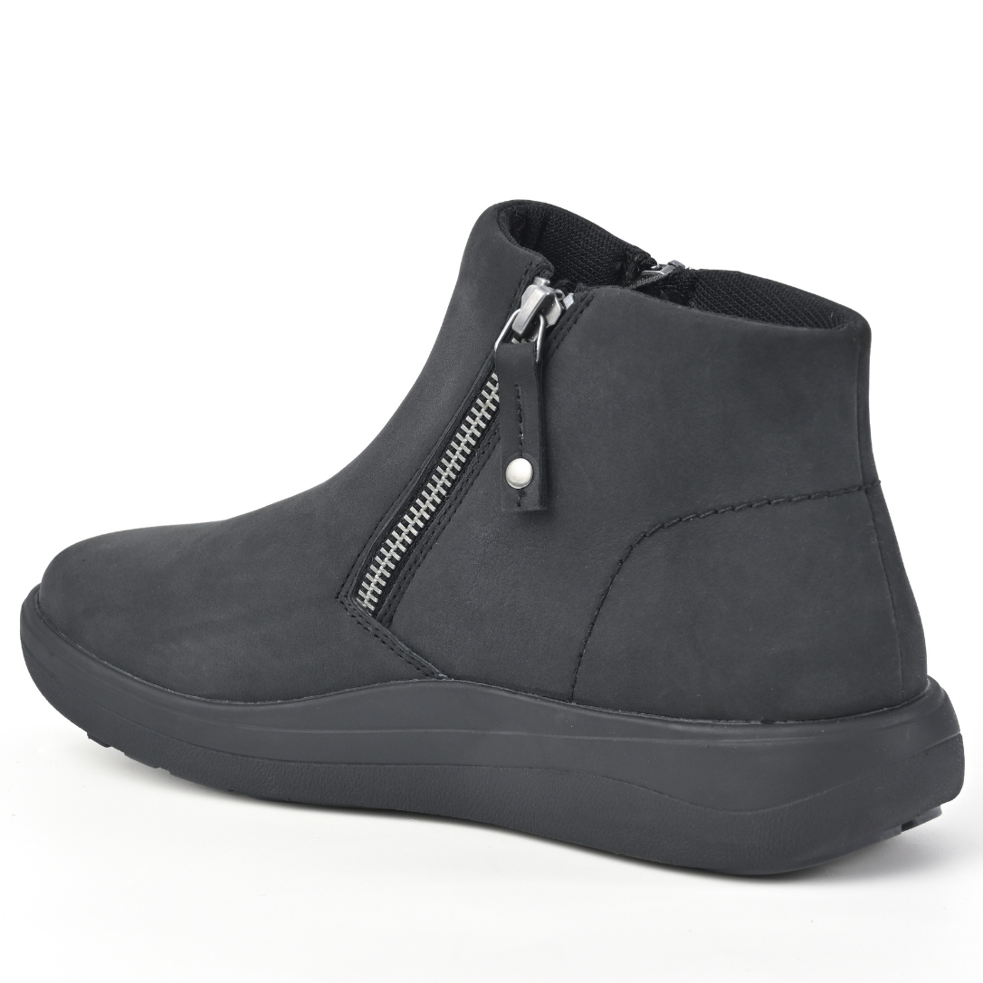 A dark grey suede ankle boot with a side zipper and a thick black sole, shown from a three-quarters angle on a white background. Strive Footwear Women’s Mayfair Black Boots