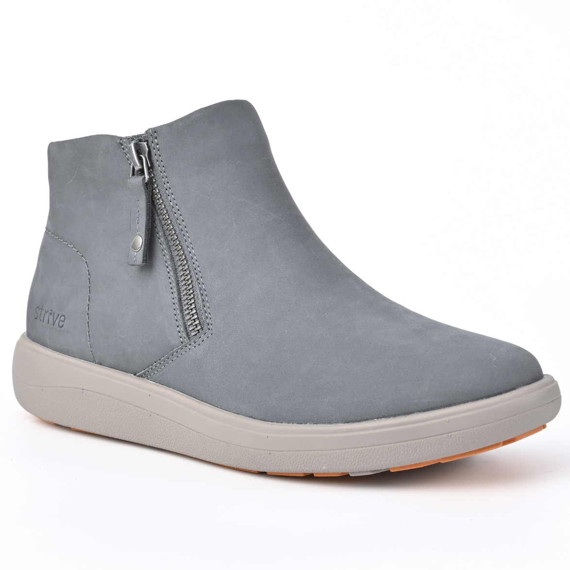A light grey suede ankle boot with a side zipper, a thick light grey sole, and a small orange outsole edge, shown on a white background. Strive Footwear Women’s Mayfair Black Boots