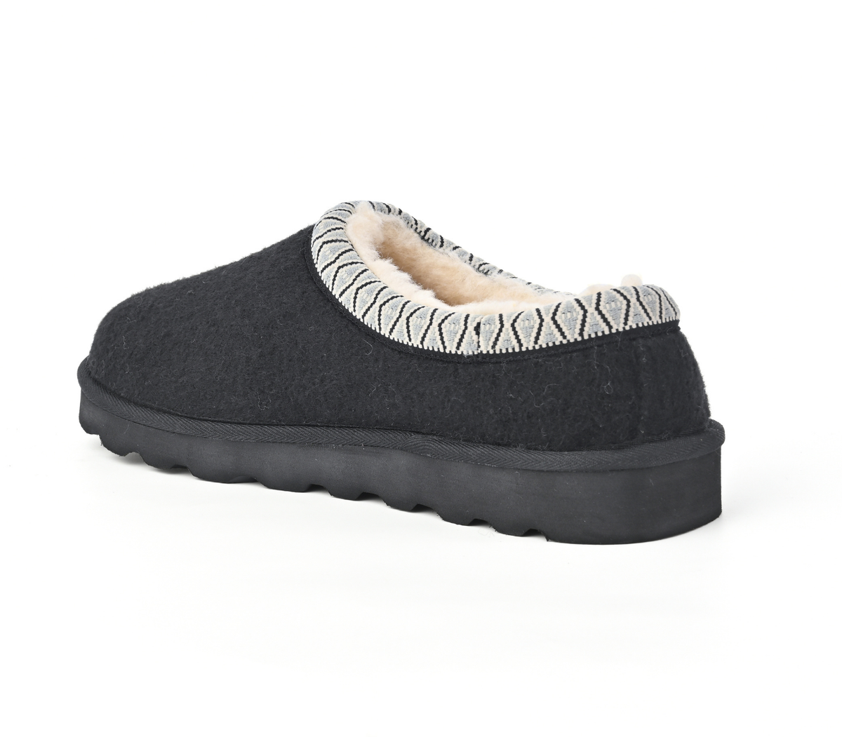A single black slip-on slouchy house shoe with a soft beige fleece lining and a patterned knit collar, shown from a three-quarters angle on a white background. Strive Footwear Zurich Felt Slippers Black