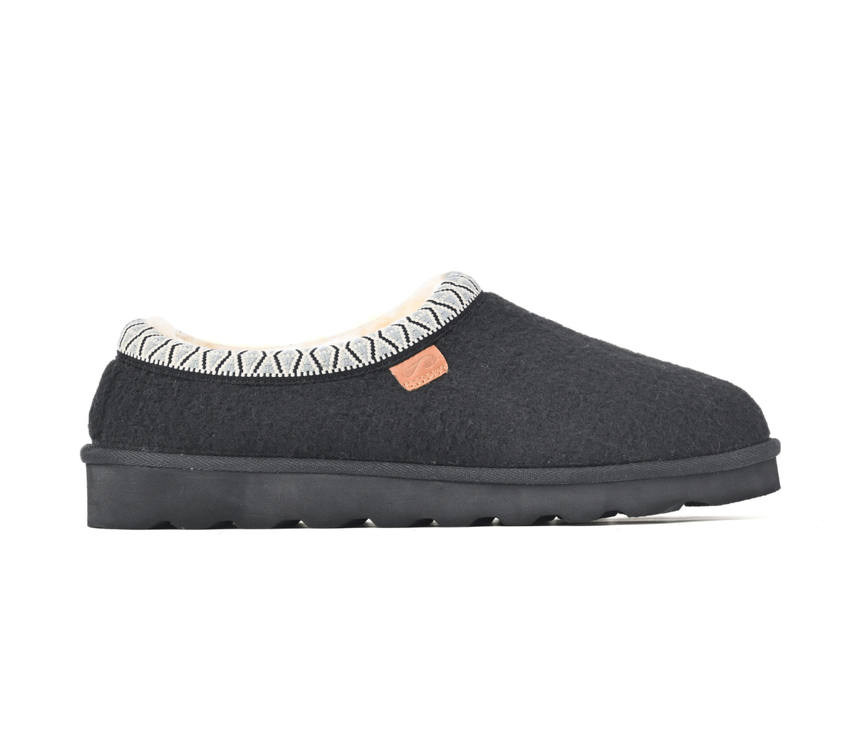 A single dark gray slip-on slouchy house shoe with a patterned cream and gray trim around the collar, a small tan leather brand tab, and a thick black sole, shown against a plain white background.
