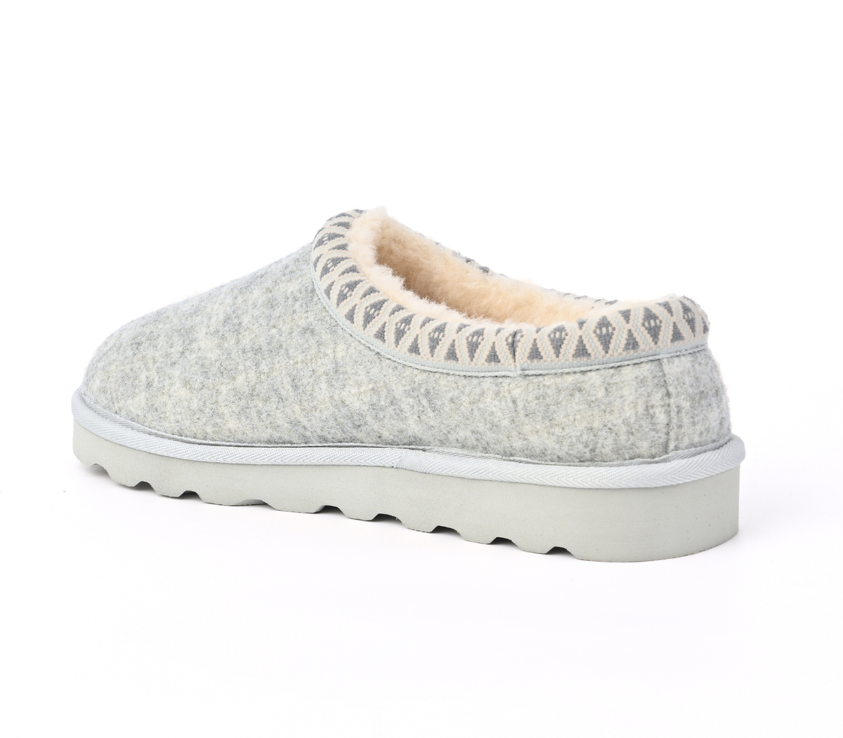 A light grey felt slip-on slipper with a soft beige fleece lining and a grey geometric pattern trim around the collar, shown from a side profile on a white background. Strive Footwear Zurich Felt Slippers Grey