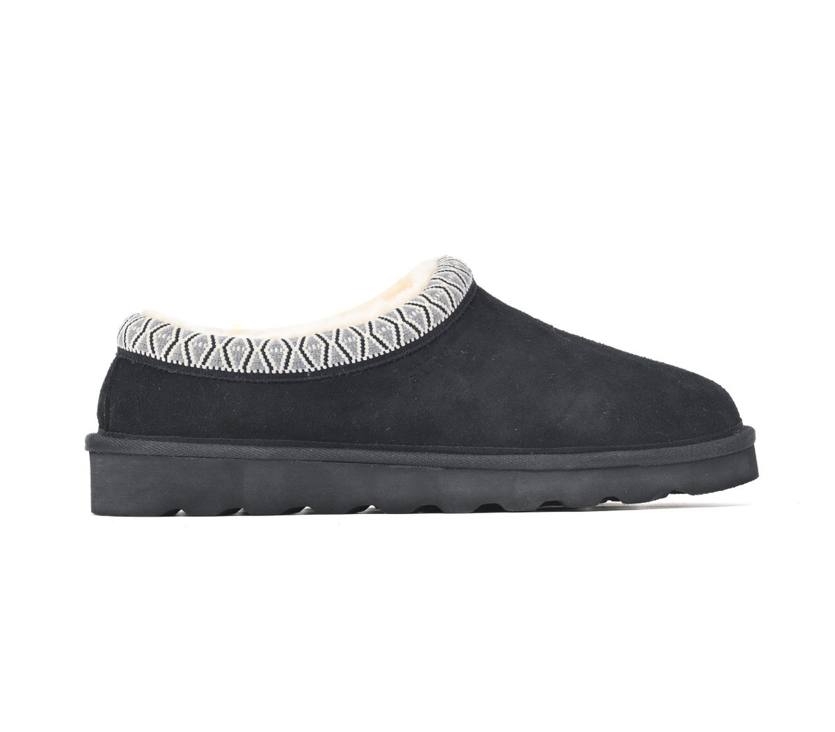 A single black slip-on clog-style shoe with a textured geometric patterned trim around the collar and a thick black sole, shown in profile against a white background. Strive Footwear Zurich Suede Slippers Black