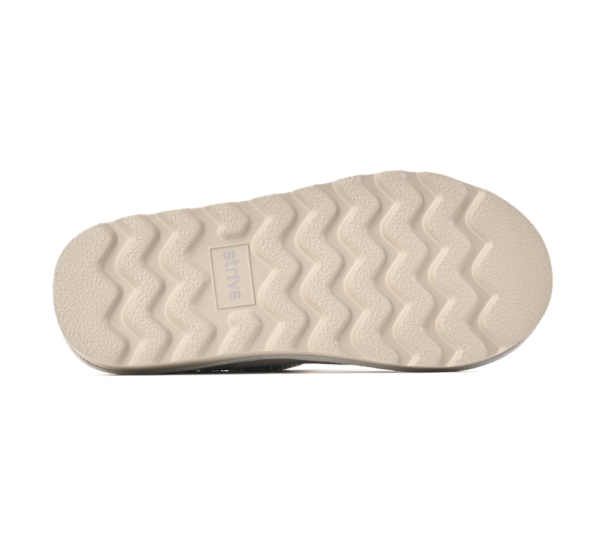 The textured beige outsole of a shoe, featuring a wavy tread pattern and a small embossed 'STRIVE' logo, shown against a plain white background.
