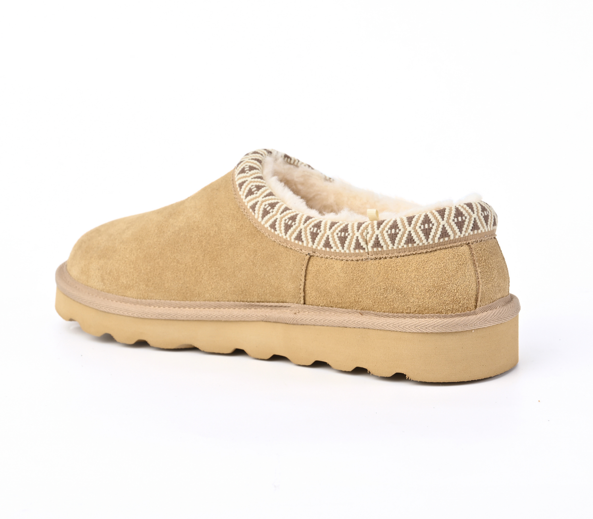 A single tan suede slipper with a cream sherpa lining and a geometric patterned trim around the collar, shown from a side profile on a white background.