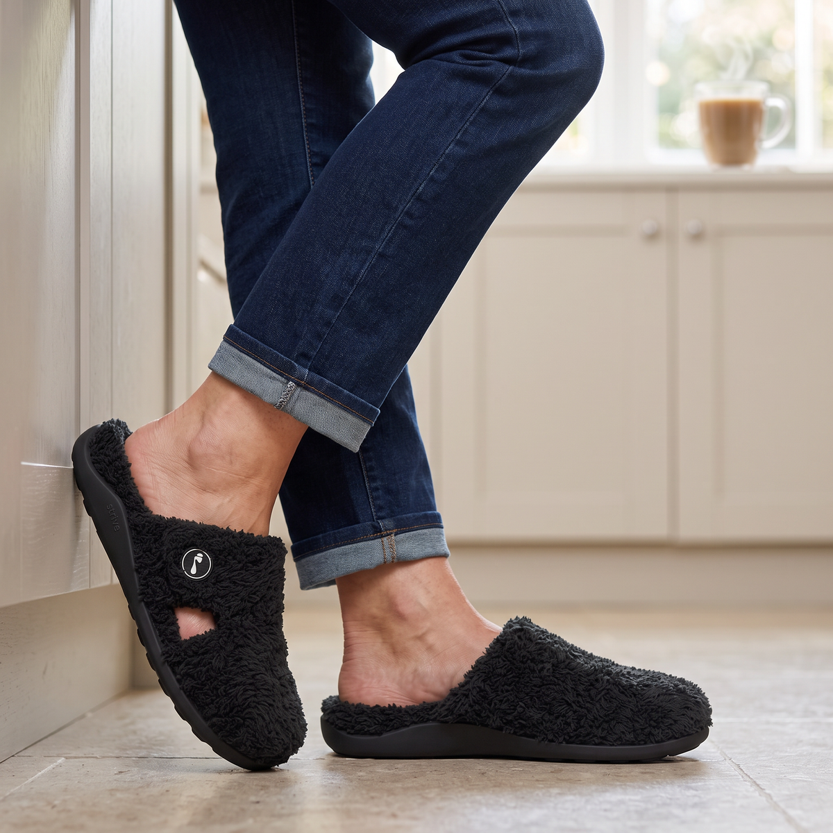 Black Strive Mayfair ankle boots with dual side zips worn outdoors